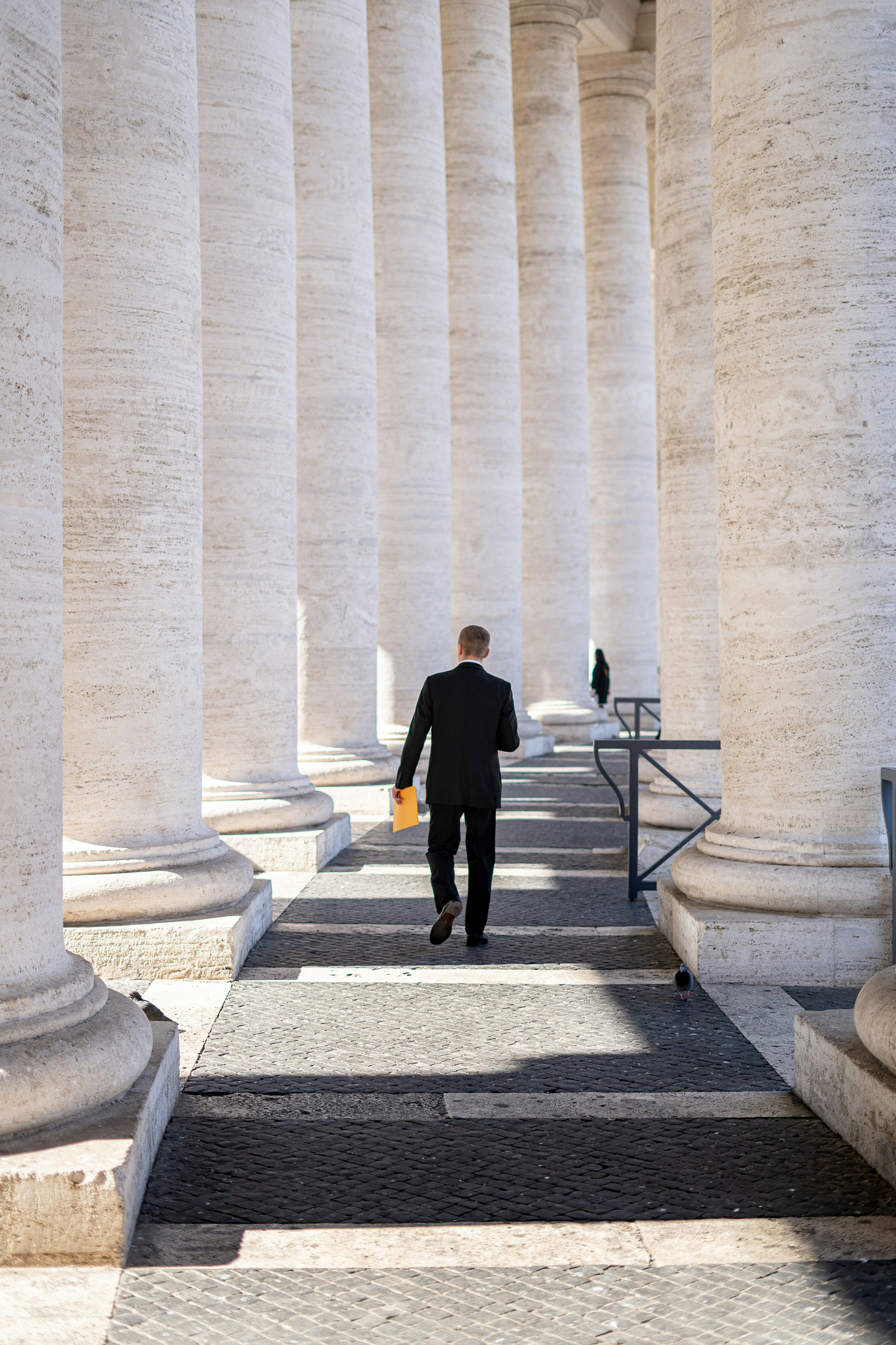 Legal expert walking through court columns